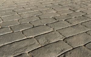 Stamped concrete pavement outdoor, mimics cobblestones pattern, decorative appearance colors and textures of paving cobble stone