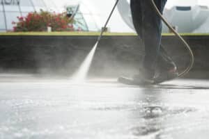 worker use high pressure pump to clean floor with detergent